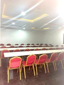 a conference room with a long table and chairs at Bridgewaters Hotel in Abuja