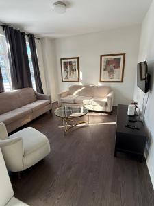 a living room with couches and a coffee table at Large 5 bedroom house in Tottenham