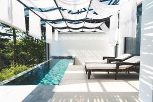 a swimming pool in the middle of a house at Tivoliville Spa N Poolvilla in Pocheon