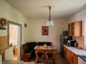 a small kitchen with a table and a couch at Gawra Bogusza in Lądek-Zdrój