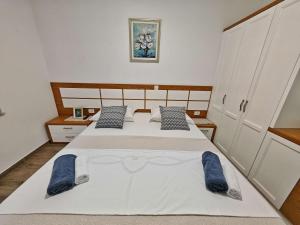 a bedroom with a large bed with blue towels on it at Villa Solaris in Donje Rašćane +31 photos