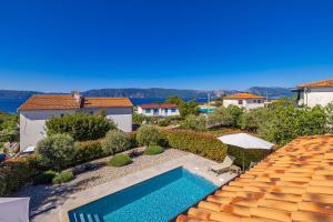 a swimming pool in the backyard of a house at Holiday house VILLA ANDRO in Pinezici