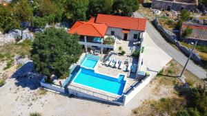 an overhead view of a house with a swimming pool at Villa Solaris in Donje Rašćane