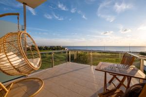a porch with a hammock and a view of the ocean at Praça da Cultura Residence in Buarcos