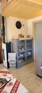 a room with a cabinet with dishes in it at Antico Borgo Fonzaso in Fonzaso