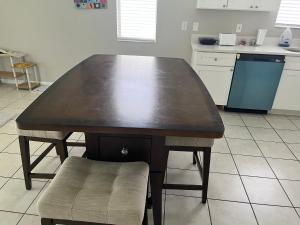 a wooden table in a kitchen with a chair at Dolphin Room in Tampa