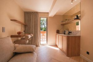 a living room with a couch and a kitchen at Casa Liana Saint-Tropez in Saint-Tropez