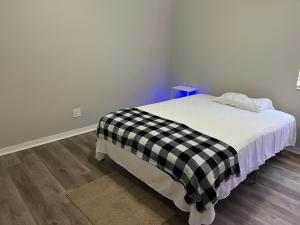 a bedroom with a bed with a black and white checkered blanket at Dolphin Room in Tampa