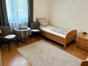 a small room with a bed and a table and chairs at Haus Sissi in Daun