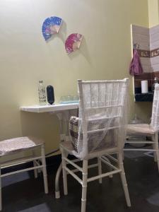 a room with two chairs and a table with mirrors at inoru house in Siliguri +9 photos