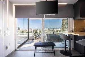 a kitchen with a table and a view of a balcony at Glyfadas's Rooftop Blyss in Athens