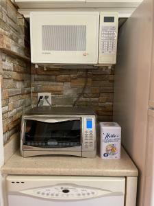 a kitchen with a microwave and a toaster oven at 2-Bedroom Suite in North Vancouver