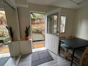 a room with a door and a table and a table at 2-Bedroom Suite in North Vancouver