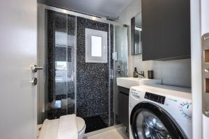 a bathroom with a washing machine and a sink at Glyfadas's Rooftop Blyss in Athens +14 photos