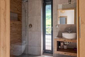 a bathroom with a sink and a shower with a mirror at Dom Przebudzeń in Porąbka +85 photos