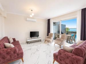 a living room with two couches and a television at Villa Azalea 1 in Ortaca