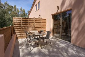 a patio with a table and chairs on a balcony at Casa Liana Saint-Tropez in Saint-Tropez