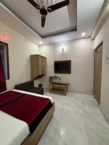a bedroom with a bed and a flat screen tv at Hotel Shifa Manor in Chāībāsa +45 photos