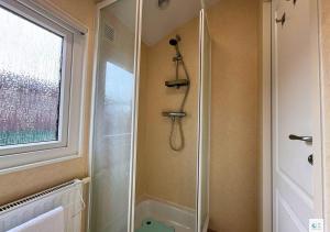 a shower in a bathroom with a window at Rupert's Lodge in West Down +27 photos