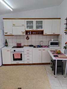 a kitchen with white appliances and a table in it at Mountain Top Eleochori Βουνοκορφή in Elaiokhórion +19 photos