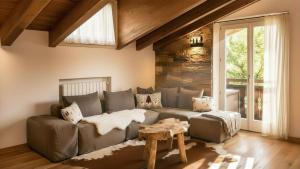 a living room with a couch and a table at Chalet la Segheria in Temù +27 photos