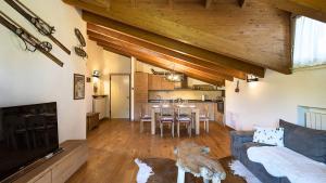 a living room with a couch and a table at Chalet la Segheria in Temù