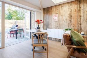 a room with a table and chairs and a dining room at The Barn at Thorpewood in Thorpe Market