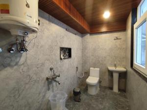 a bathroom with a toilet and a sink at Hotel Oakland Landour in Mussoorie +27 photos