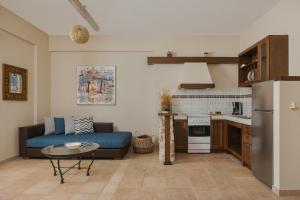 a living room with a couch and a kitchen at Niriides Luxury Apartments in Syvota +31 photos