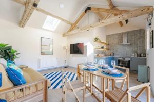 a kitchen and living room with a table and chairs at The Cove at Thorpewood in Thorpe Market +8 photos