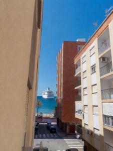 a cruise ship in the water between buildings at Piso Almería playa in Almería
