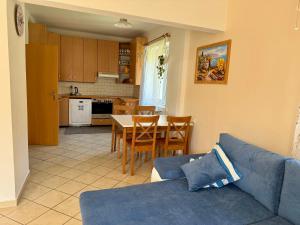 a living room with a blue couch and a table at Apartmán U ŘEKY in Srbsko