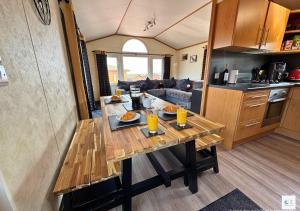 a kitchen with a wooden table in a tiny house at Rupert's Lodge in West Down