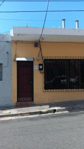 a building with a red door on the side of a street at Apartamento en la Zona Colonial in Santo Domingo