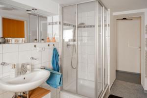 a bathroom with a sink and a shower at Haus Treff in Weissenbach am Lech +60 photos