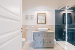 a bathroom with a sink and a shower at Dimora Dell'Erbe Apartments in Montepulciano +55 photos