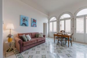 a living room with a couch and a table at Dimora Dell'Erbe Apartments in Montepulciano