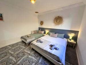 a bedroom with a large bed with two stuffed animals on it at Villa Massalia Essaouira in Essaouira +41 photos