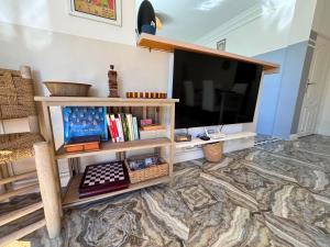 a living room with a large flat screen tv at Villa Massalia Essaouira in Essaouira