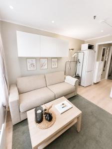a living room with a couch and a table at Koselig studioleilighet i sentrum in Trondheim