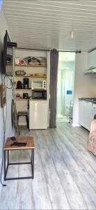 a room with a refrigerator and a table in it at Le cocooning in Andernos-les-Bains