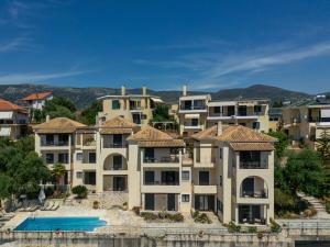 a row of apartment buildings next to a body of water at Niriides Luxury Apartments in Syvota