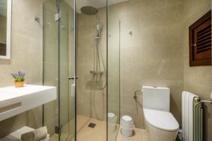 a bathroom with a shower and a toilet and a sink at Cala Figuera Apartment 4b in Cala Figuera +10 photos