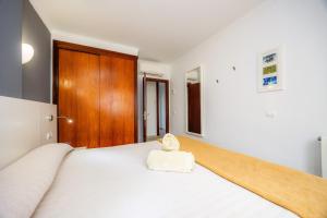 a bedroom with a bed with a towel on it at Cala Figuera Apartment 4b in Cala Figuera