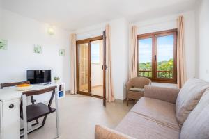 a living room with a couch and a table at Cala Figuera Apartment 4b in Cala Figuera