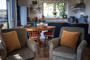 a kitchen with two chairs and a table at Saltspring Lodge in Oban