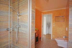 a bathroom with a shower and a toilet at Strandvilla Börgerende in Börgerende-Rethwisch +23 photos