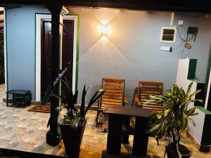 a room with a table and some plants and a wall at Sigiriya Rock Gate Resort in Sigiriya