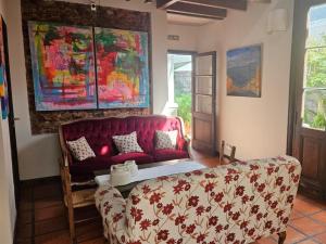 a living room with a red couch and a table at Posada Gotan in Buenos Aires +21 photos