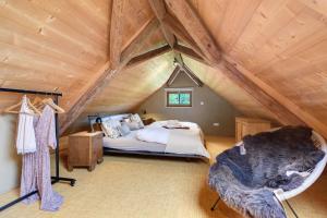 a bedroom with a bed in an attic at Hofgut Heiligenberg in Heiligenberg